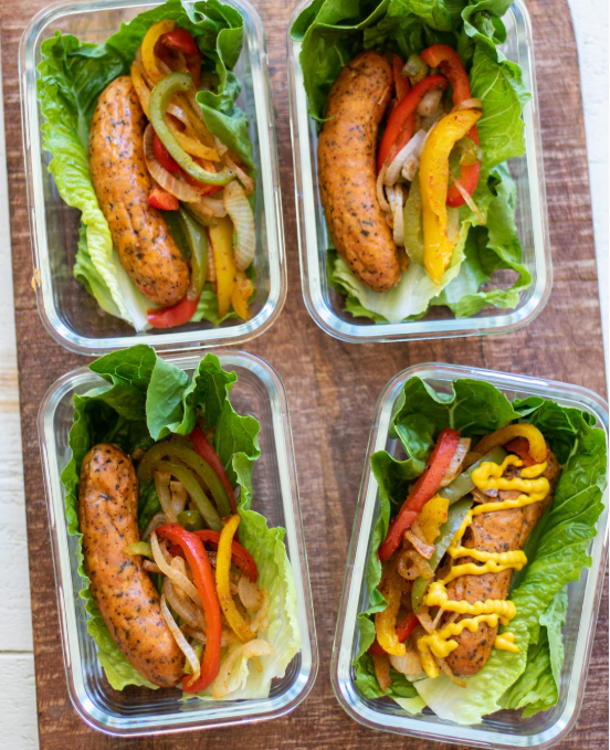 Four sausage wraps in containers with sides.