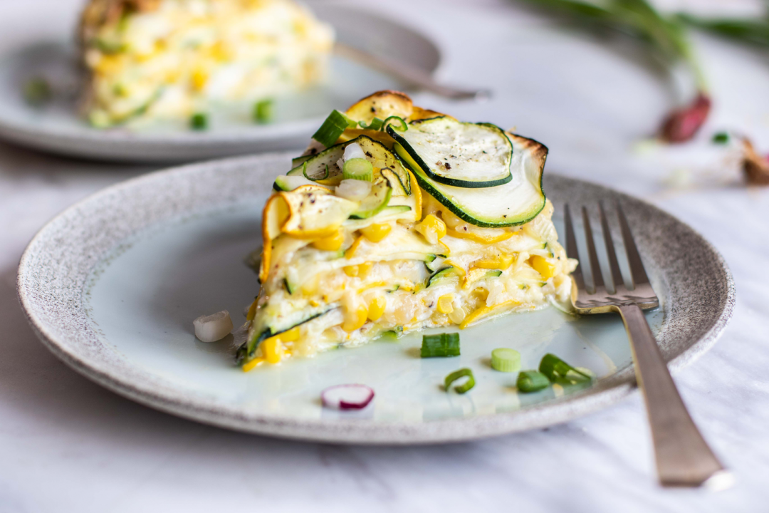 Sweet Corn Zucchini Pie on a plate with a fork.