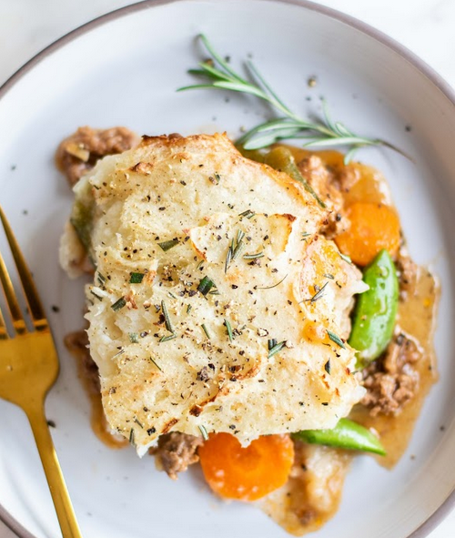 Whole30 Shepherd's Pie Recipe on a white plate next to a fork.
