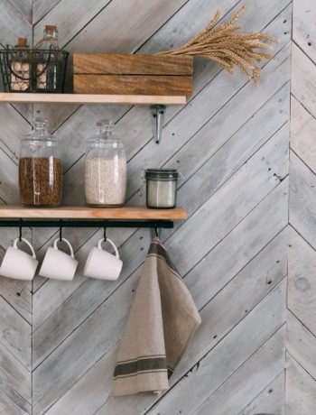 Modern shelving design holding kitchen products on a wooden wall.