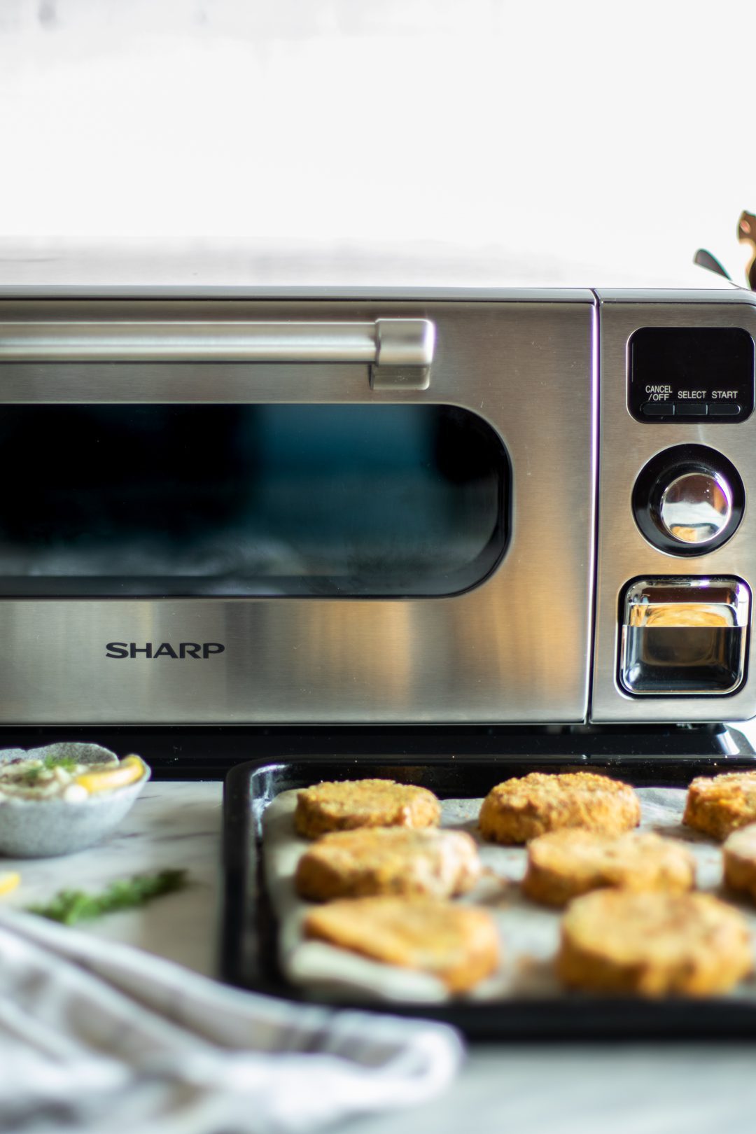 A tray of food outside of a Sharp Supersteam Countertop Oven.