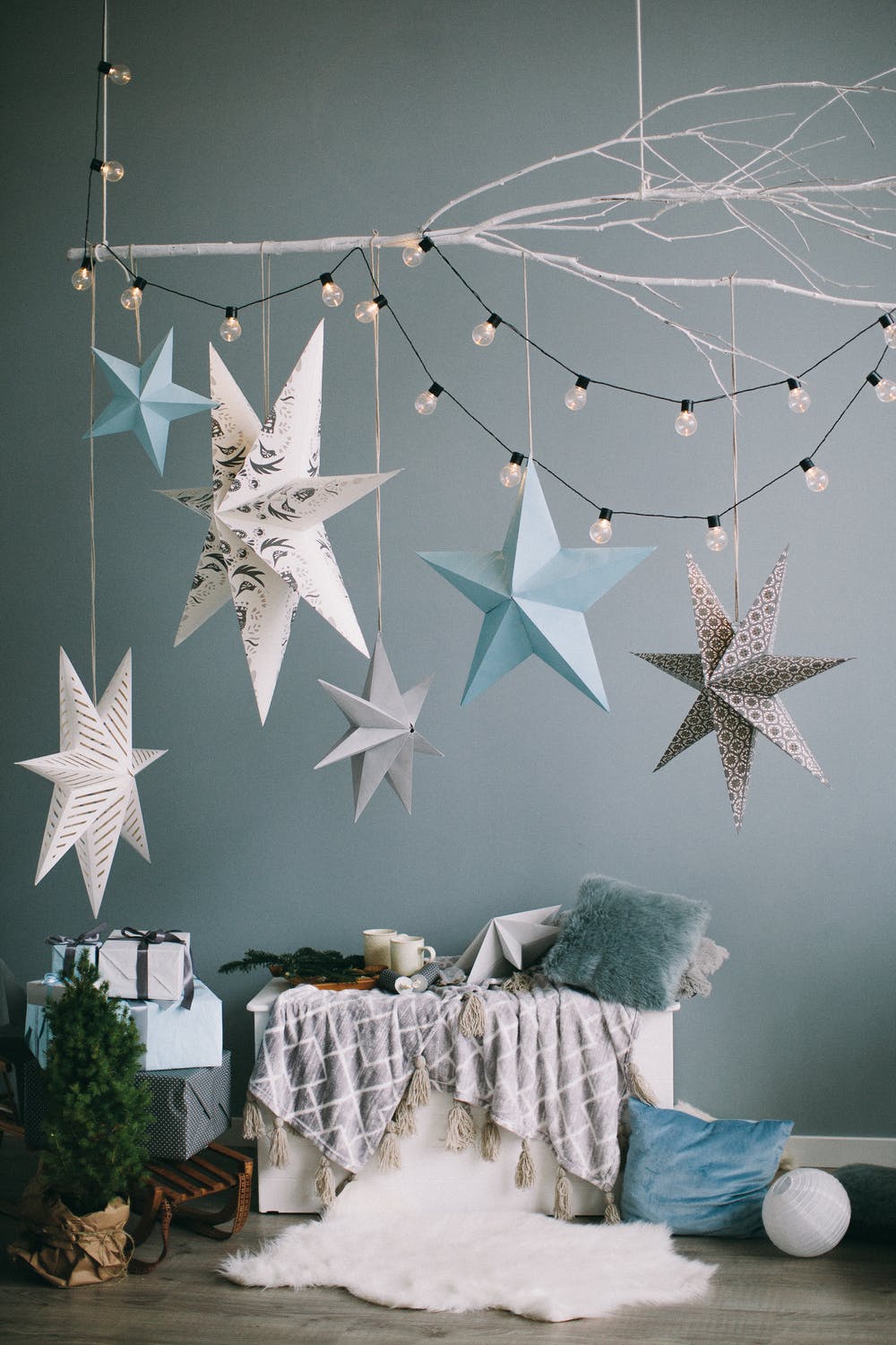 Stars, lights, and pillows next to wall decor.