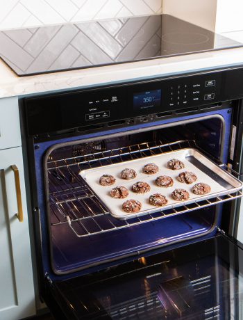 Cookies spread on a tray in a Sharp oven.