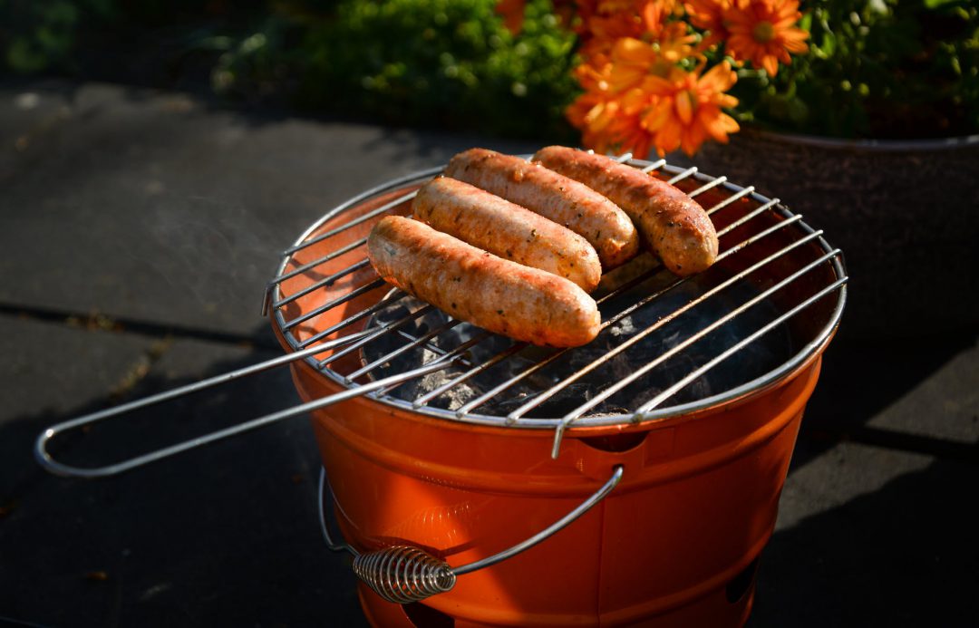 Hot dogs on a charcoal grill