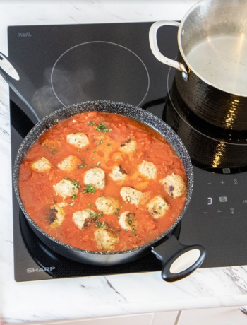 Food simmering in pan on an induction cooktop
