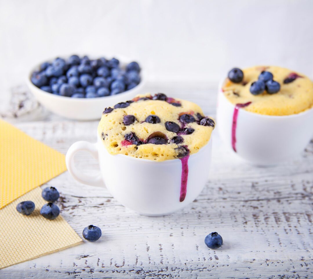 mug with blueberry cake baked in it