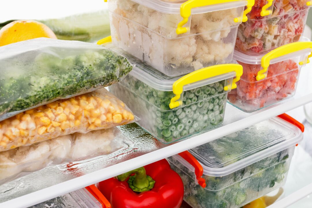 frozen food containers in freezer shelves