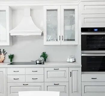 A modern white kitchen with a Sharp Built-In Double Wall Oven (SWB3062GS).