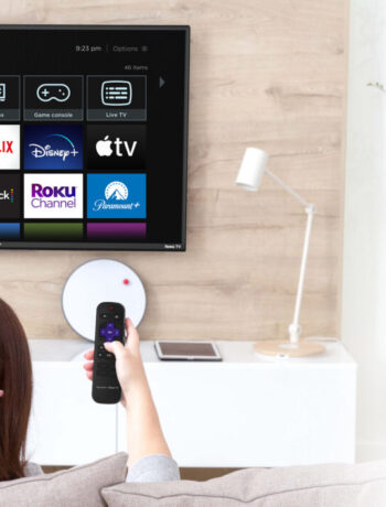 Woman watching a Sharp Roku TV OLED 4k Ultra HD with HRD10 TV