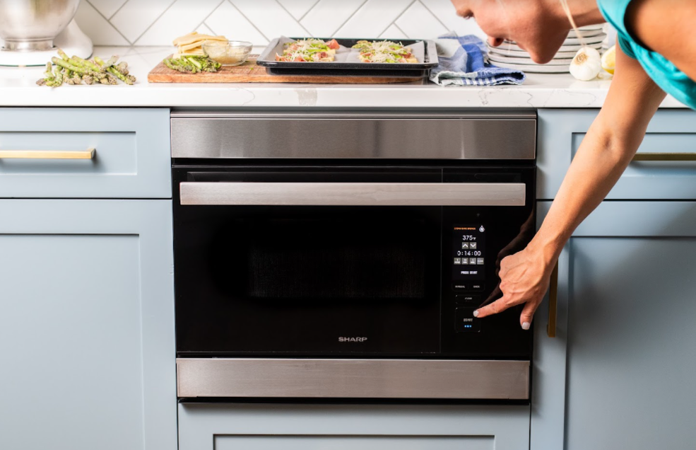 person interacting with Sharp oven