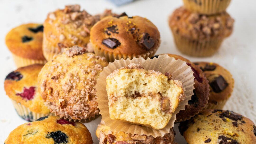 A pile of a variety of muffins.