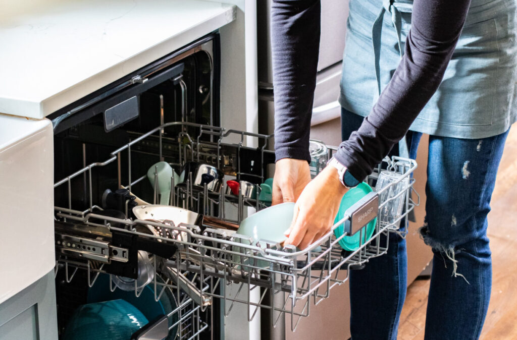 woman loading a dishwasher