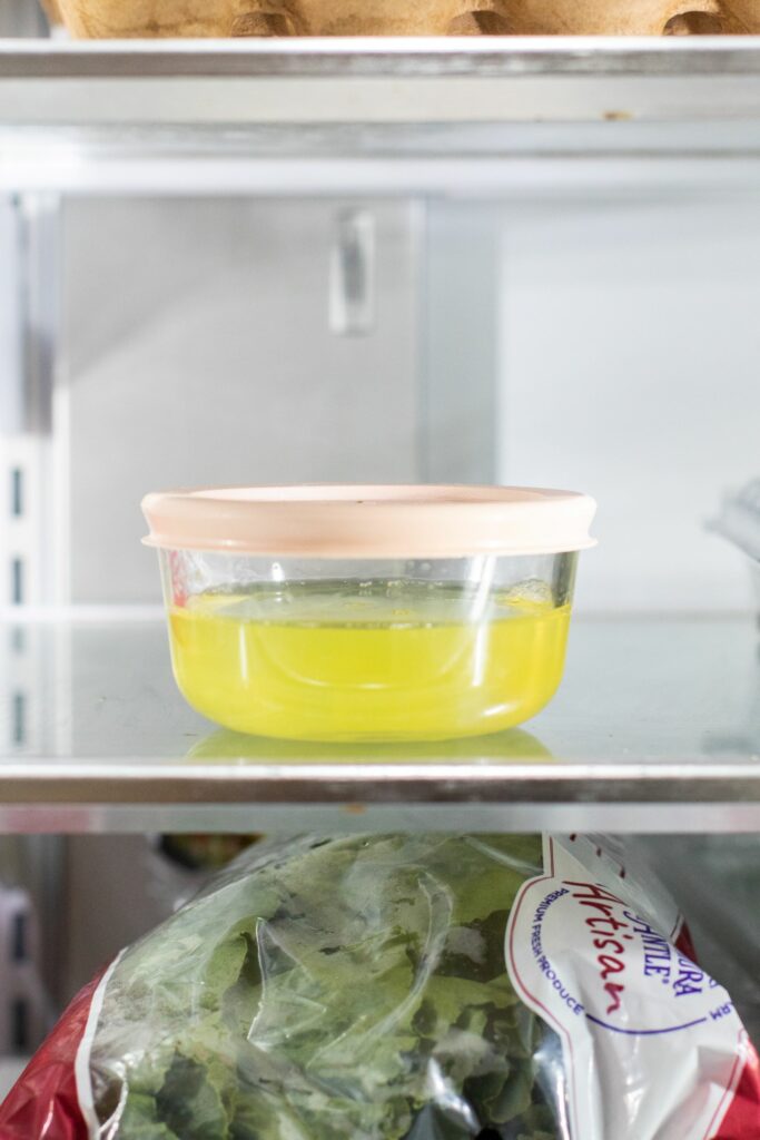 Egg whites resting in a glass storage bowl in the refrigerator