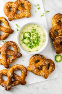 Soft pretzels plated with dipping sauce