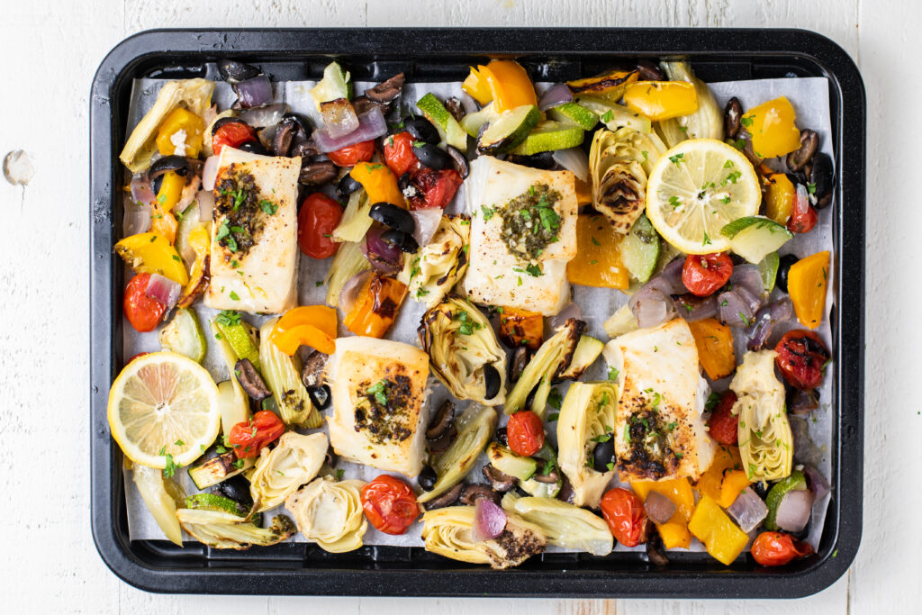 Chilean sea bass on a tray with vegetables