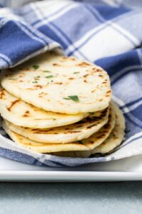 Gluten Free Flatbread in a blue and white pattern napkin on a serving dish