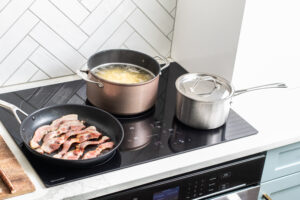 Pots and pans on a Sharp Induction Cooktop cooking pasta and bacon