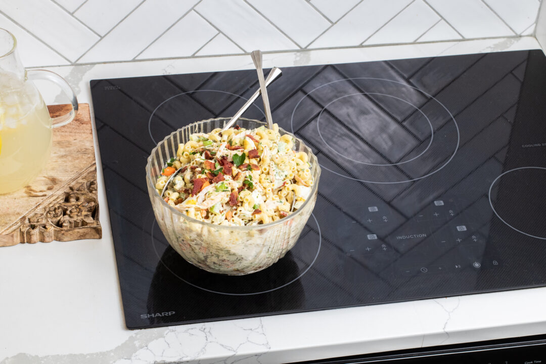 Chicken Macaroni Salad in a serving bowl on a Sharp Cooktop