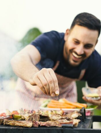 man cooking on a grill