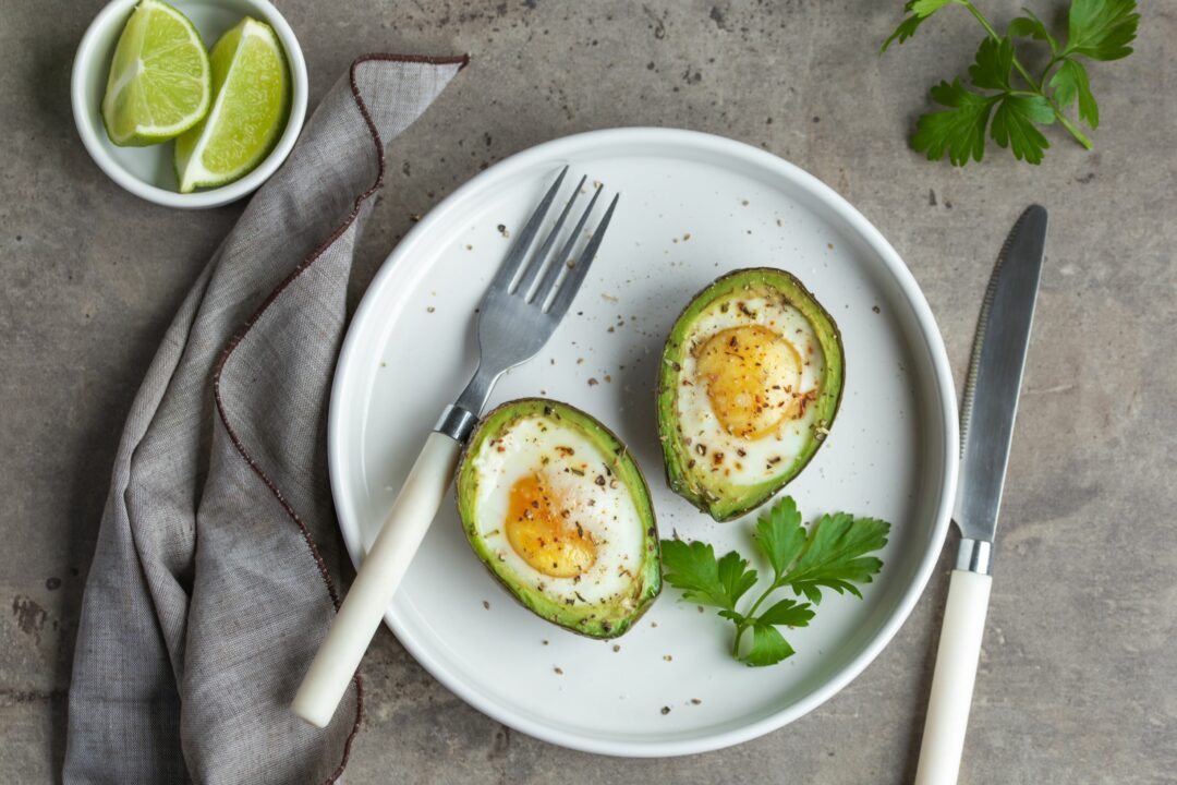 plate with eggs over avocados