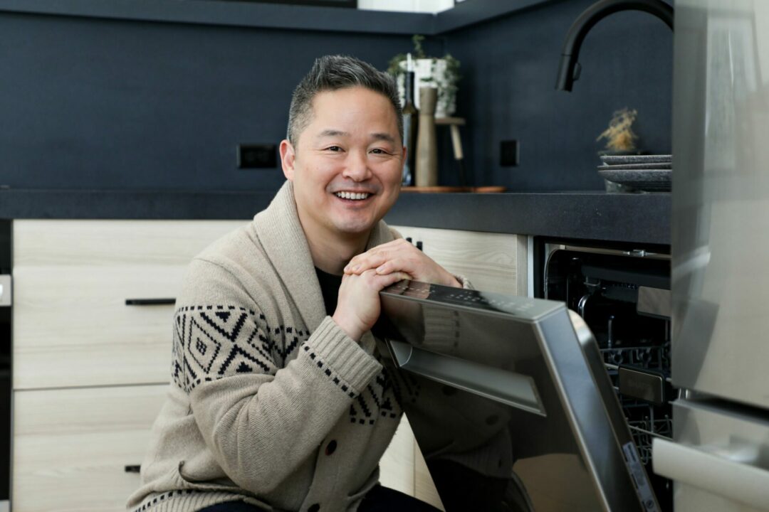 Danny Seo with a Sharp dishwasher in a clean kitchen