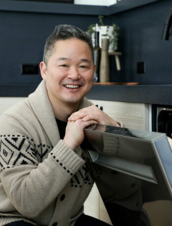 Danny Seo with a Sharp dishwasher in a clean kitchen
