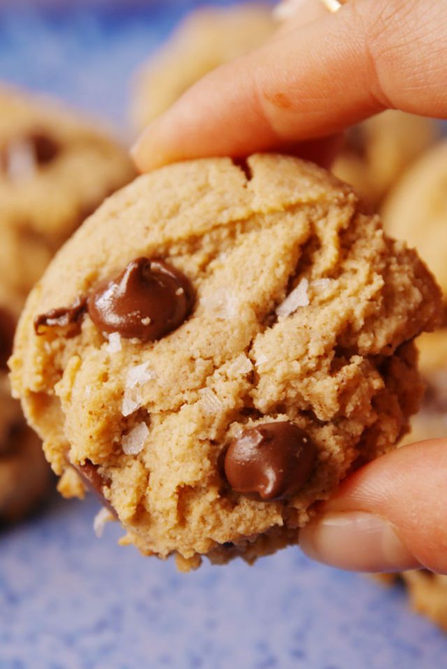 Paleo chocolate chip cookies being held by a hand.