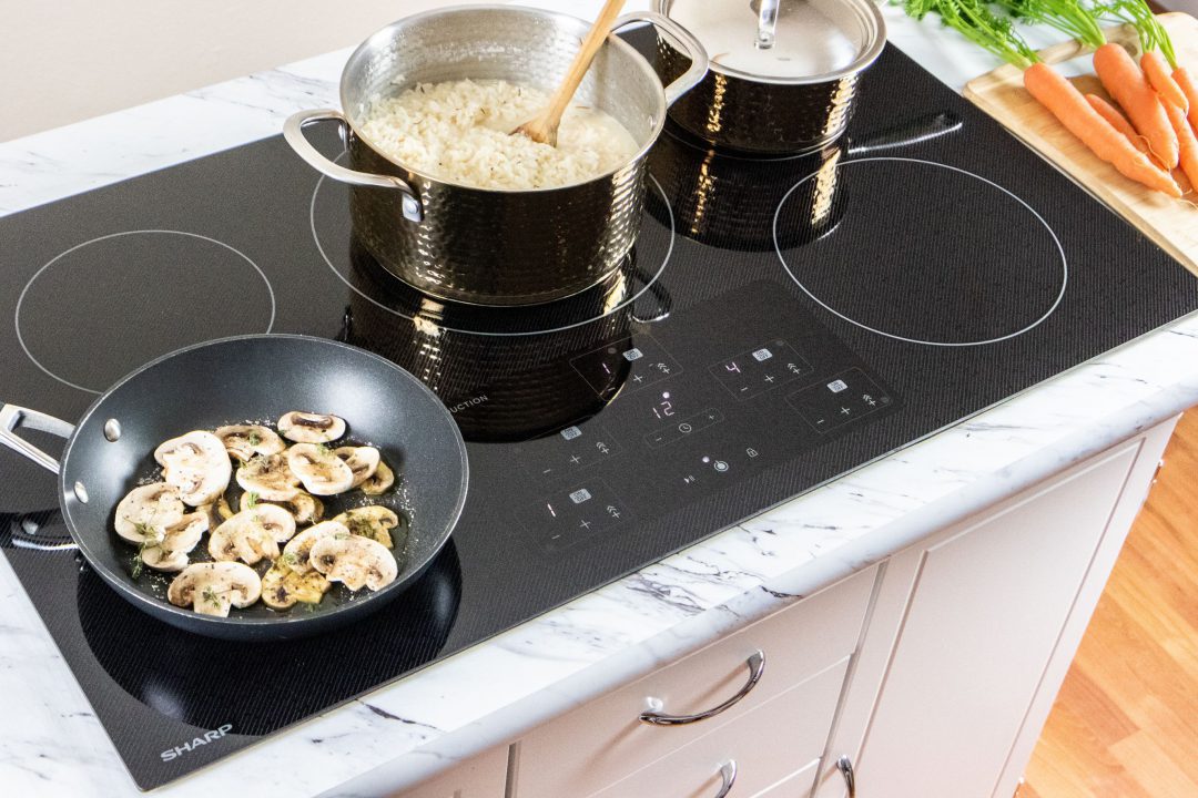 pots and pans cooking food on an induction cooktop