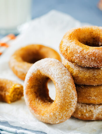 A stack of donuts on parchment paper
