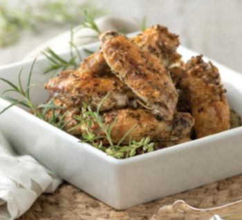 Herbed chicken in a square dish.