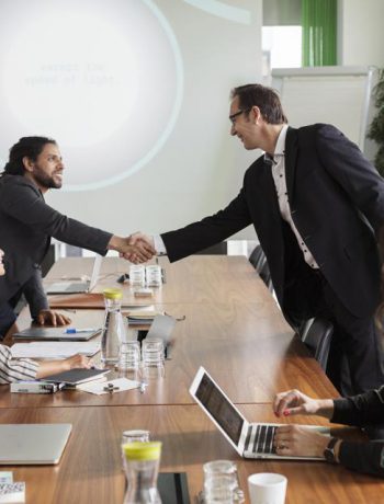 business people shaking hands in a conference room