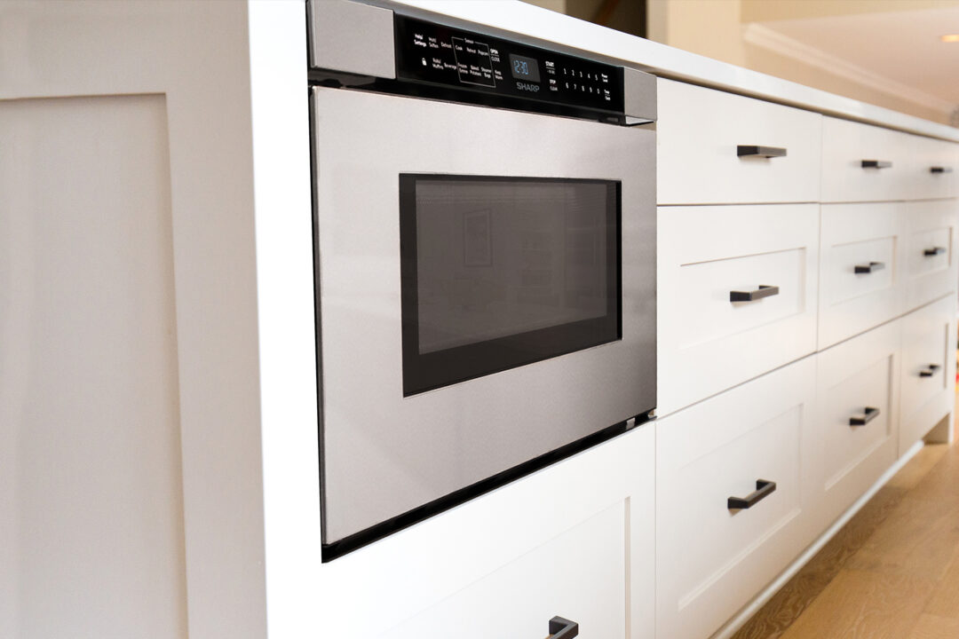A Sharp Microwave Drawer Oven (SMD2440JS) in a kitchen.