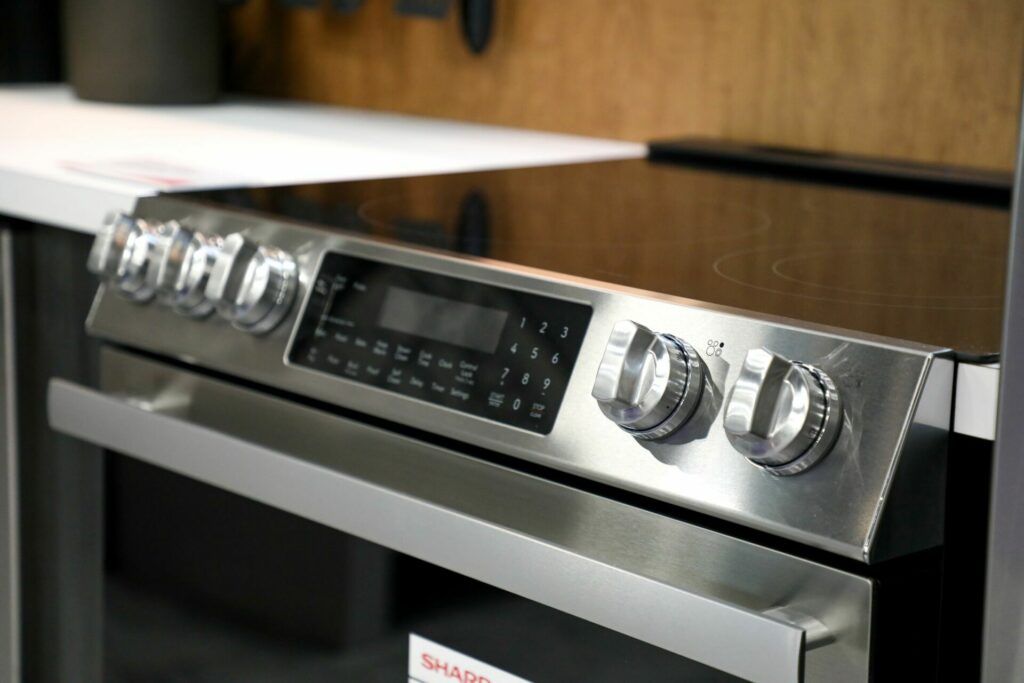 Sharp Electric Range SSR3065JS in a kitchen showcasing the smooth cooktop and stainless steel exterior finish