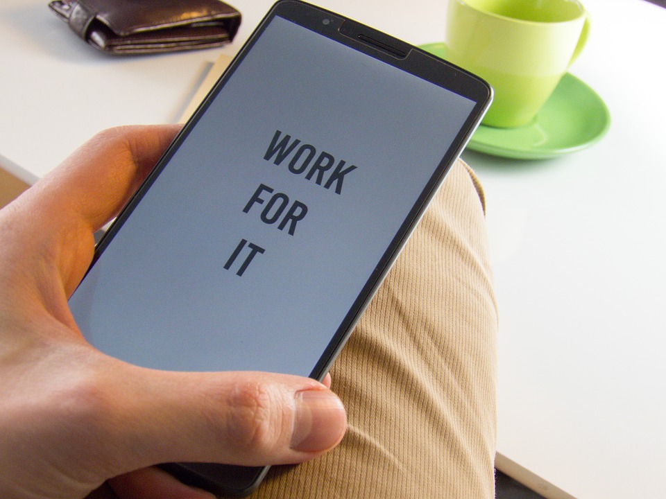 Motivation quote "Work For It" on a smartphone.