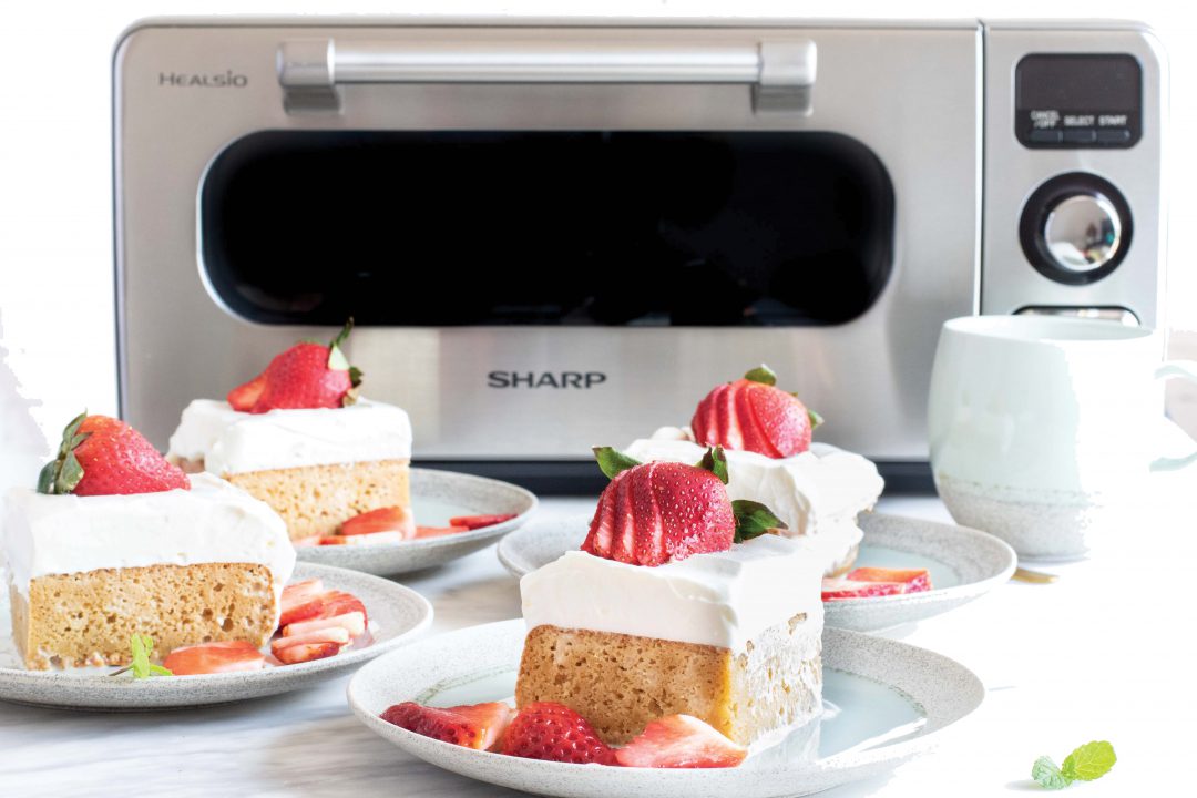 Four cakes on plates next to Sharp Supersteam Countertop Oven.