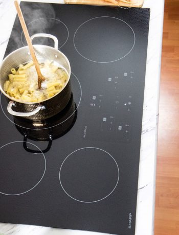 Pasta cooking in a 3pot on an induction cooktop.