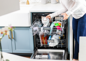 Woman cleaning out SHARP Dishwasher