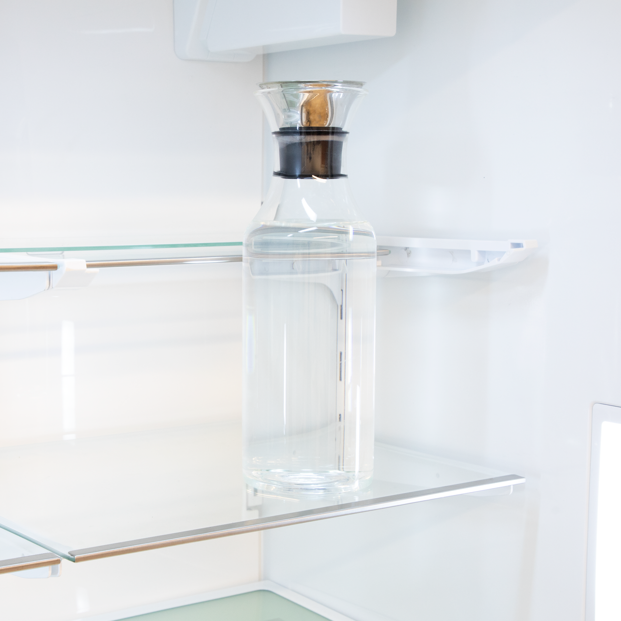 Sharp French 4-Door Counter-Depth Refrigerator with Water Dispenser (SJG2254FS) – interior view of slide-in shelf with water bottle