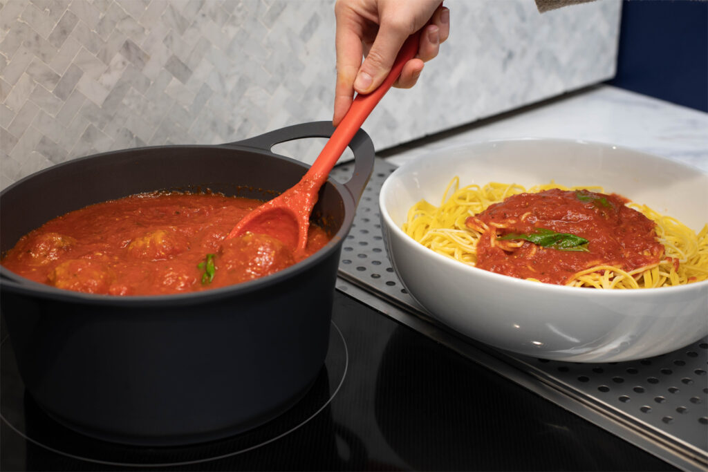 Spaghetti and sauce being prepared on a Sharp Radiant Cooktop