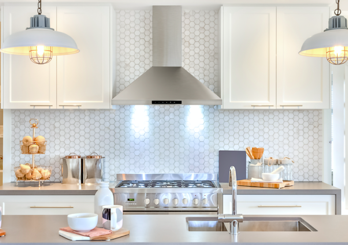 SHARP Range Hood with lights on in a white kitchen