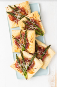 Cooked Asparagus Prosciutto Tarts on white serving plate