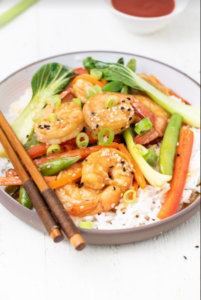 shrimp stir fry over rice in bowl