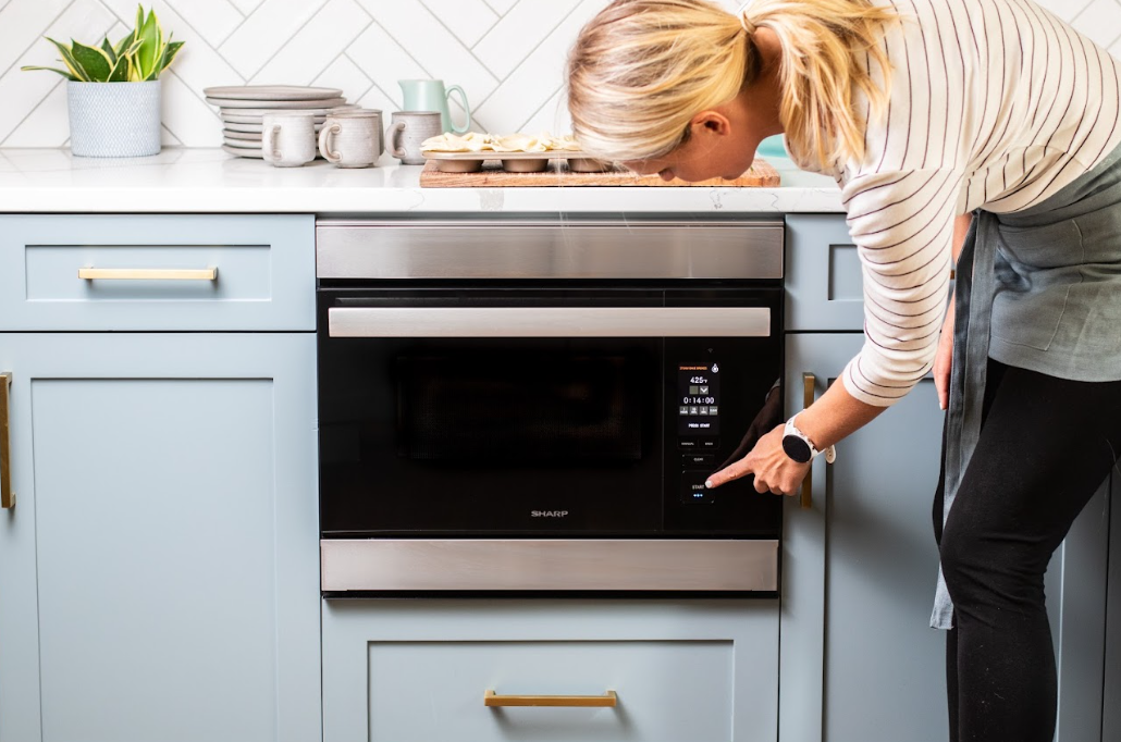 woman cooking using a sharp superheated steam oven