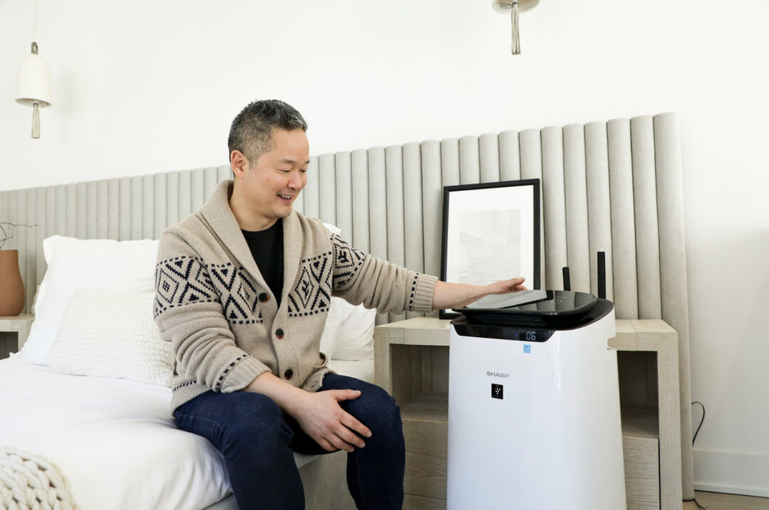 Danny Seo next to our Sharp Smart Plasmacluster Ion Air Purifier (FXJ80UW).