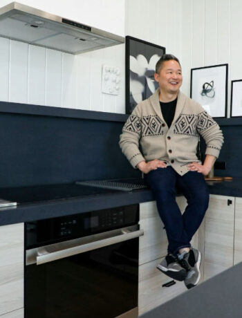 Danny Seo in the Serenbe model home sitting next to the Sharp 24 in. Built-In Single Wall Oven (SWA2450GS)