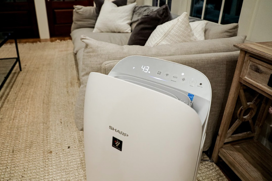 The Sharp Smart Plasmacluster Ion Air Purifier with True HEPA + Humidifier for Large Rooms (KCP70UW) in a large room.