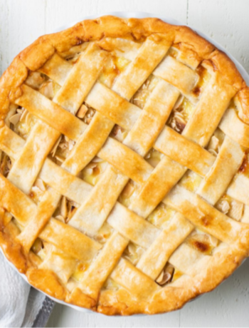 image of an apple pie on a counter with table settings