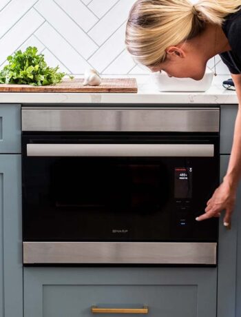 SHARP Supersteam Wall Oven with woman pressing buttons