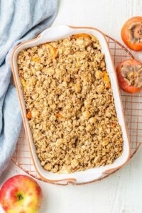 SK Persimmon Apple Crisp finished in a dish on a cooling tray