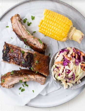 BBQ ribs, corn and coleslaw on a plate